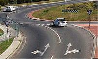 Driver Knowledge Test Australia - Car Intersections - When you wish to drive straight ahead at a roundabout you may enter from either the left or right lane. As you continue around you should: